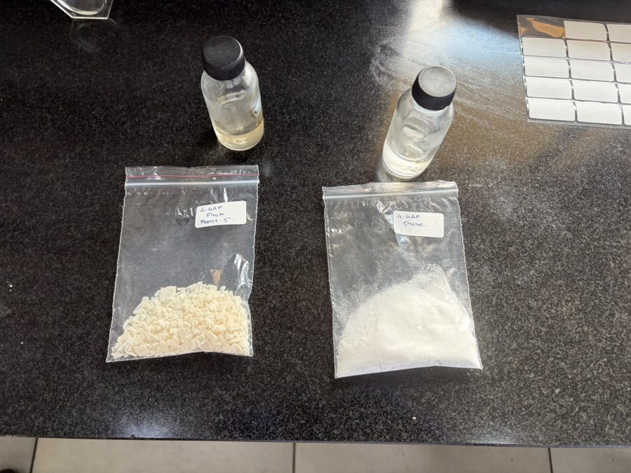 Crude cream flakes beside white recrystallised 4-HAP